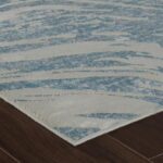 Modern textured rug on wooden floor
