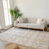 Modern living room with gray sofa and geometric rug.