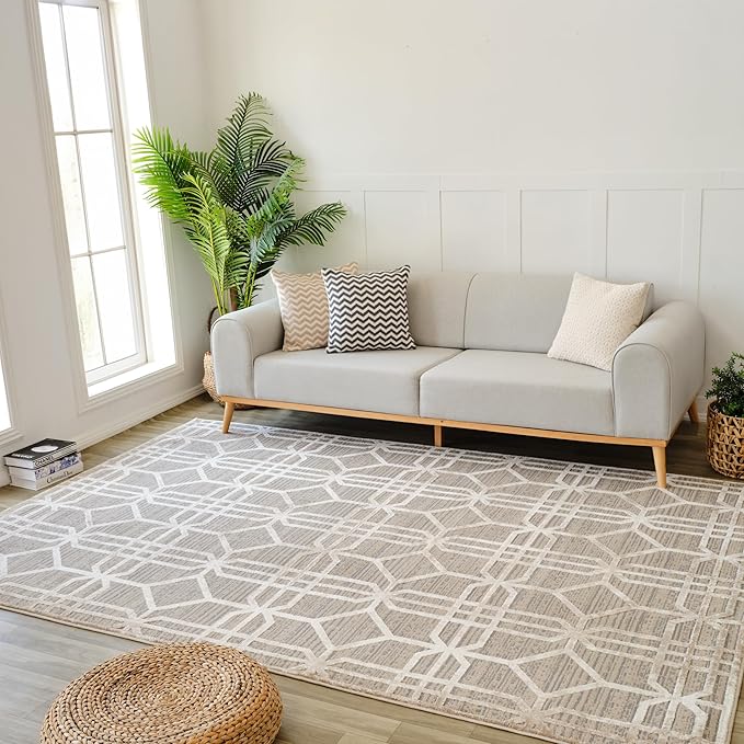 Modern living room with gray sofa and geometric rug.