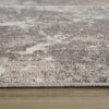 Close-up of textured gray woven rug on floor.