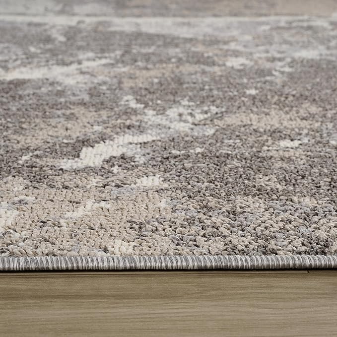 Close-up of textured gray woven rug on floor.