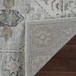 Patterned rug corner on wooden floor