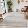 Modern living room with patterned rug and decor.