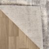 Gray textured rug on wooden floor