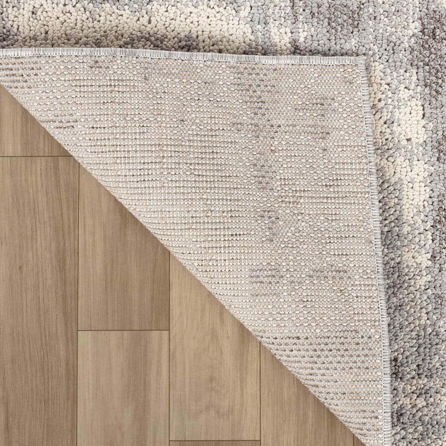 Gray textured rug on wooden floor