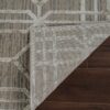 Corner of a rug flipped on wooden floor