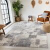 Modern living room with geometric rug and plants.