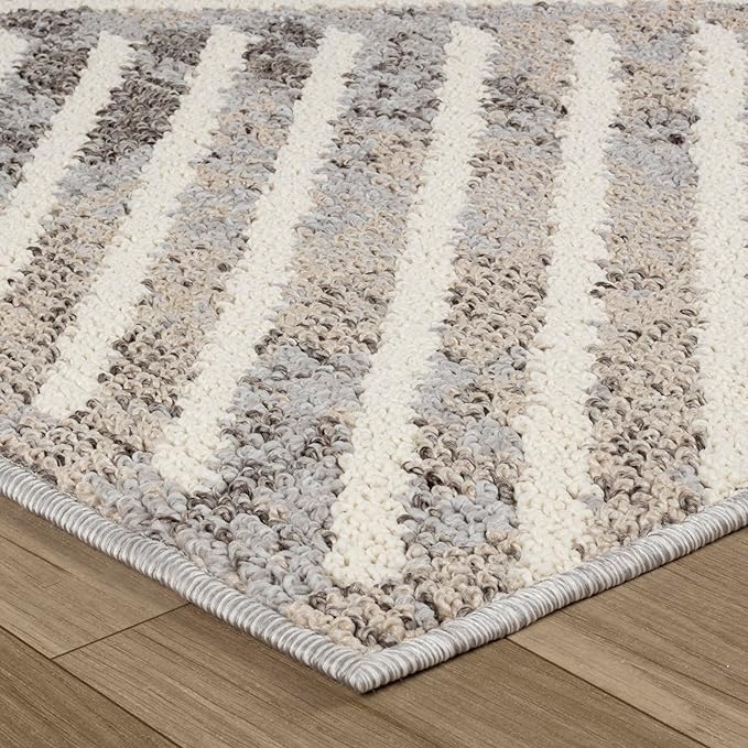 Textured gray and white striped area rug on floor.