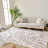 Modern living room with gray sofa and patterned rug.