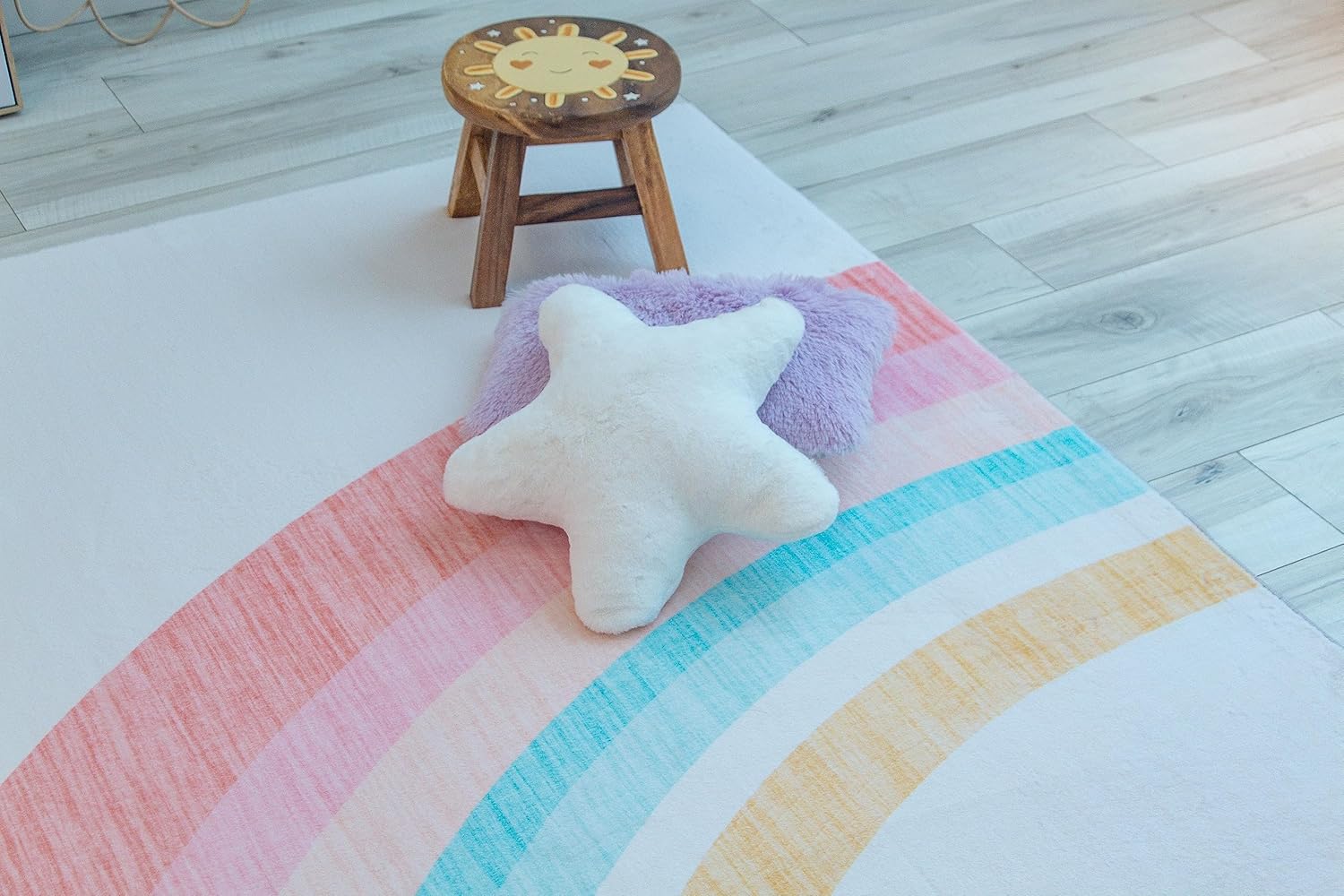 Colorful playroom rug with pillow and stool
