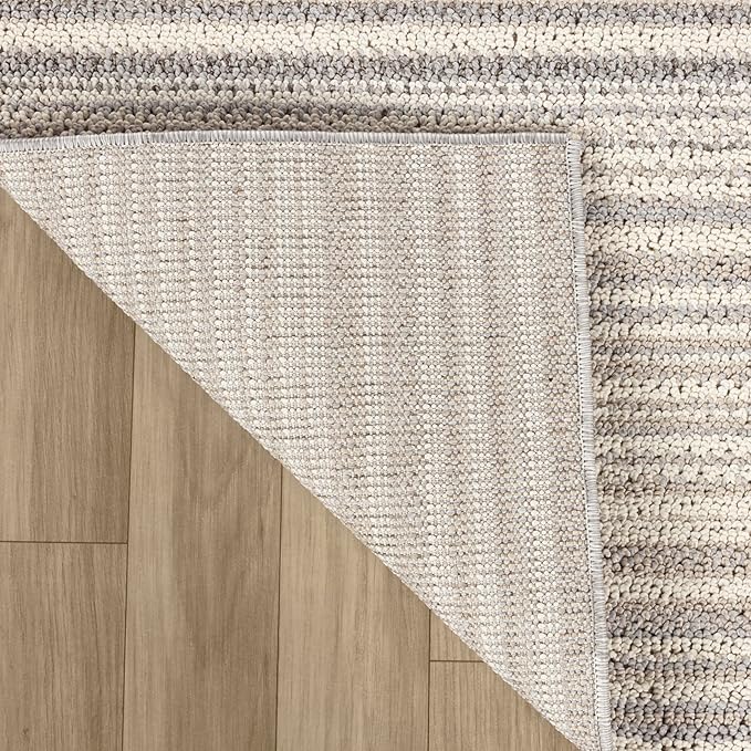Gray textured rug on wooden floor