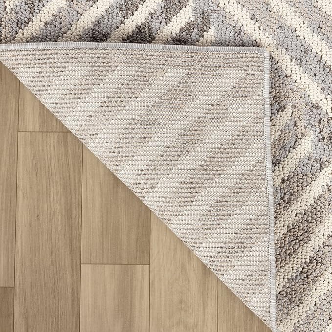 Beige textured rug corner on brown floor