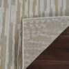 Patterned rug corner folded on wooden floor