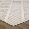Beige textured rug on wooden floor