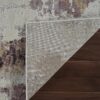 Colorful abstract rug on wooden floor.