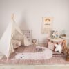 Cozy kids' playroom with toys and tipi tent.