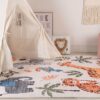 Kids' room with animal-themed rug and tent.