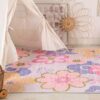 Colorful floral rug next to a play tent.
