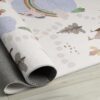 Rolled mat with playful design on wood floor