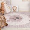 Nursery decor with giraffe toy and lion rug.