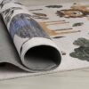 Colorful animal-themed kids rug on wooden floor.