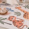 Colorful animal-themed rug in nursery room.