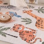 Colorful animal-themed rug in nursery room.