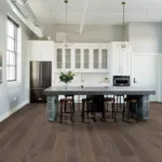 Modern kitchen with island and bar stools.