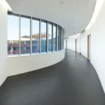 Curved office corridor with large windows