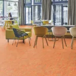 Modern cafe lounge with orange flooring.