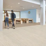 Two people walking in a modern lobby