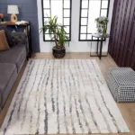 Modern living room with striped area rug.