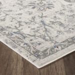 Gray floral area rug on wooden floor