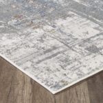 Gray and white rug on wooden floor