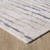 Gray and beige striped area rug on wood floor.