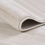 Close-up of folded beige carpet corner