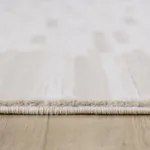 Close-up of beige carpet on wooden floor