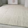 Beige rug with vertical lines on floor