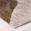 Textured beige and brown rug on light floor