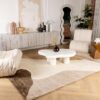 Modern living room with abstract decor and furniture.