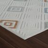 Patterned rug with geometric squares on hardwood floor.