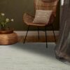 Cozy chair with cushion in a stylish room.