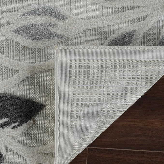 Gray floral rug corner on wooden floor