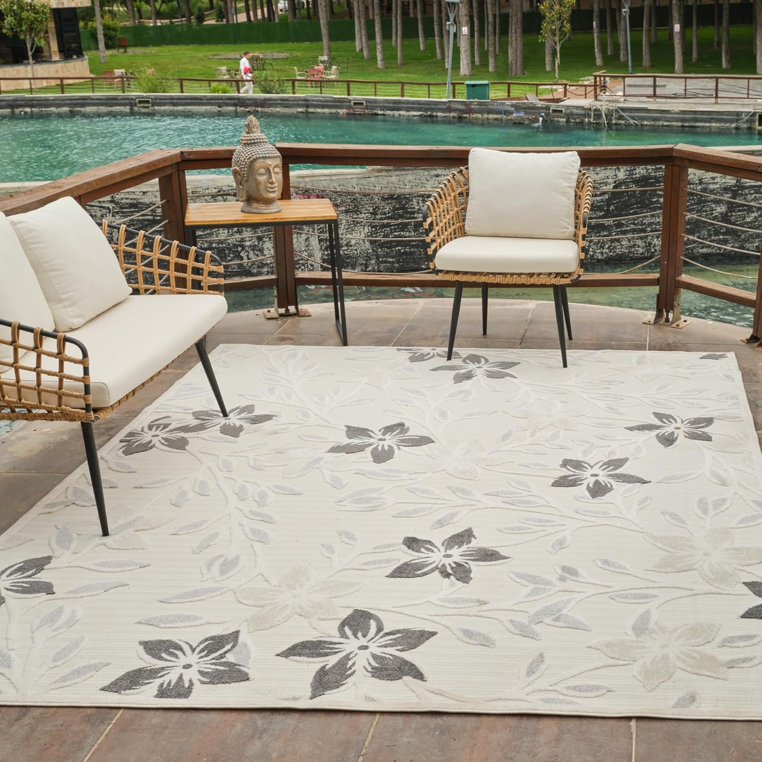 Outdoor seating area with decorative floral rug.