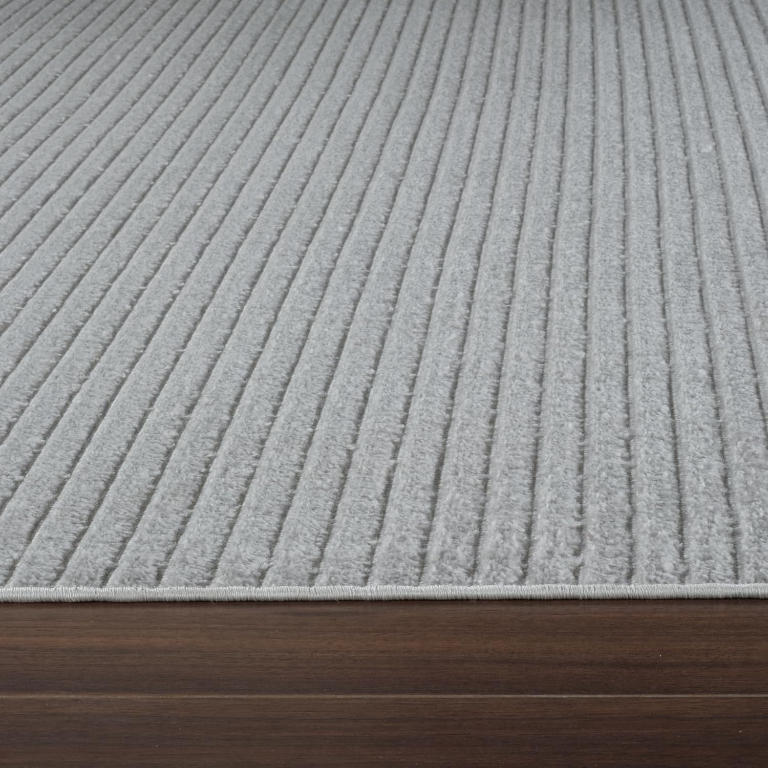 Gray ribbed carpet with wooden edge