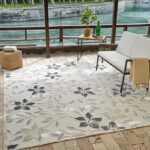 Outdoor floral rug on patio by the river.