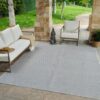 Outdoor patio with furniture and gray rug