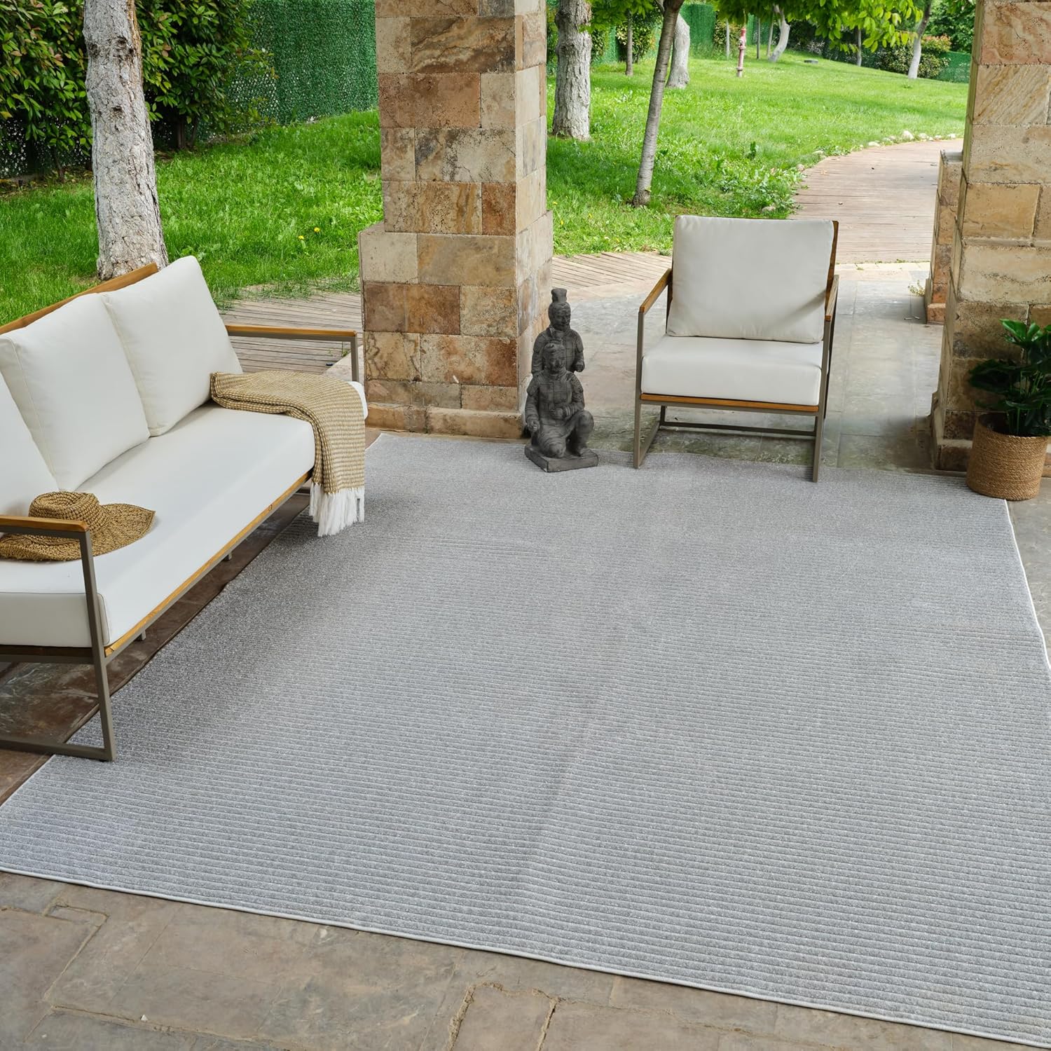 Outdoor patio with furniture and gray rug