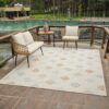 Outdoor seating area with geometric pattern rug.