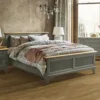 Cozy bedroom with wooden bed frame and decor.